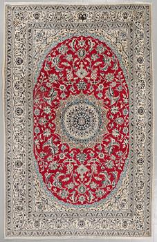 A Nain rug, part silk, 306 x 194 cm.