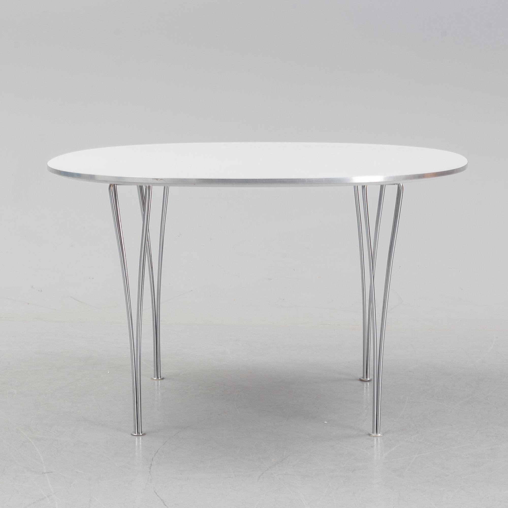 A 'Supercircular' table by Bruno Mathsson & Piet Hein for Fritz Hansen, dated 1985.