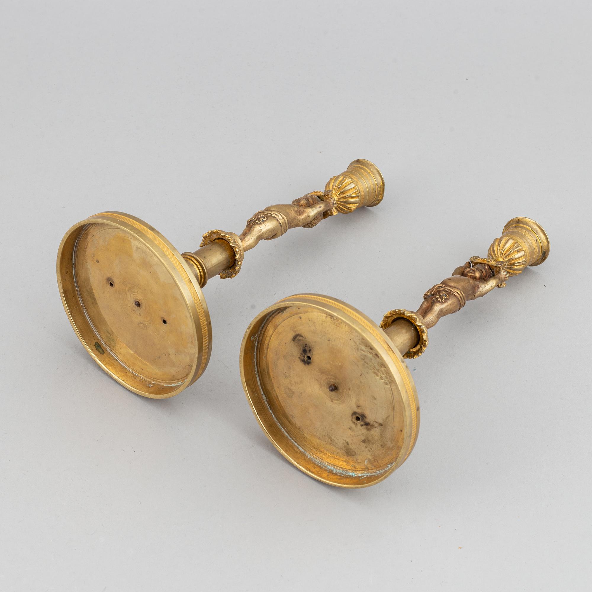 A pair of 19th Century bronze empire style candlesticks.