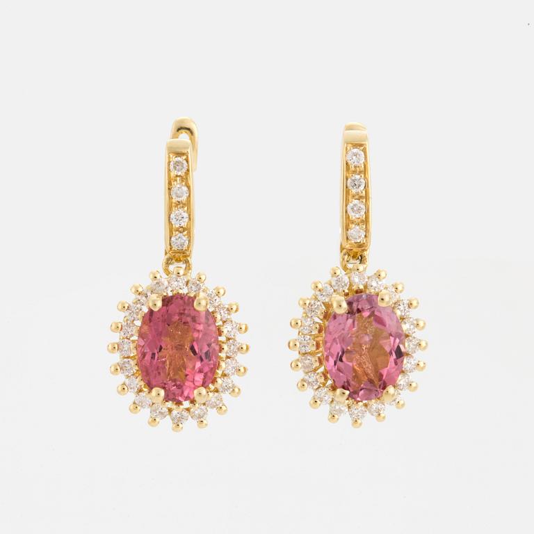 A pair of earrings set with pink tourmalines and diamonds.