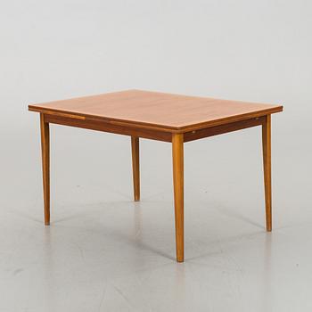 A TEAK DINNER TABLE.