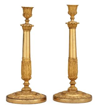 768. A pair of Empire early 19th century candlesticks.