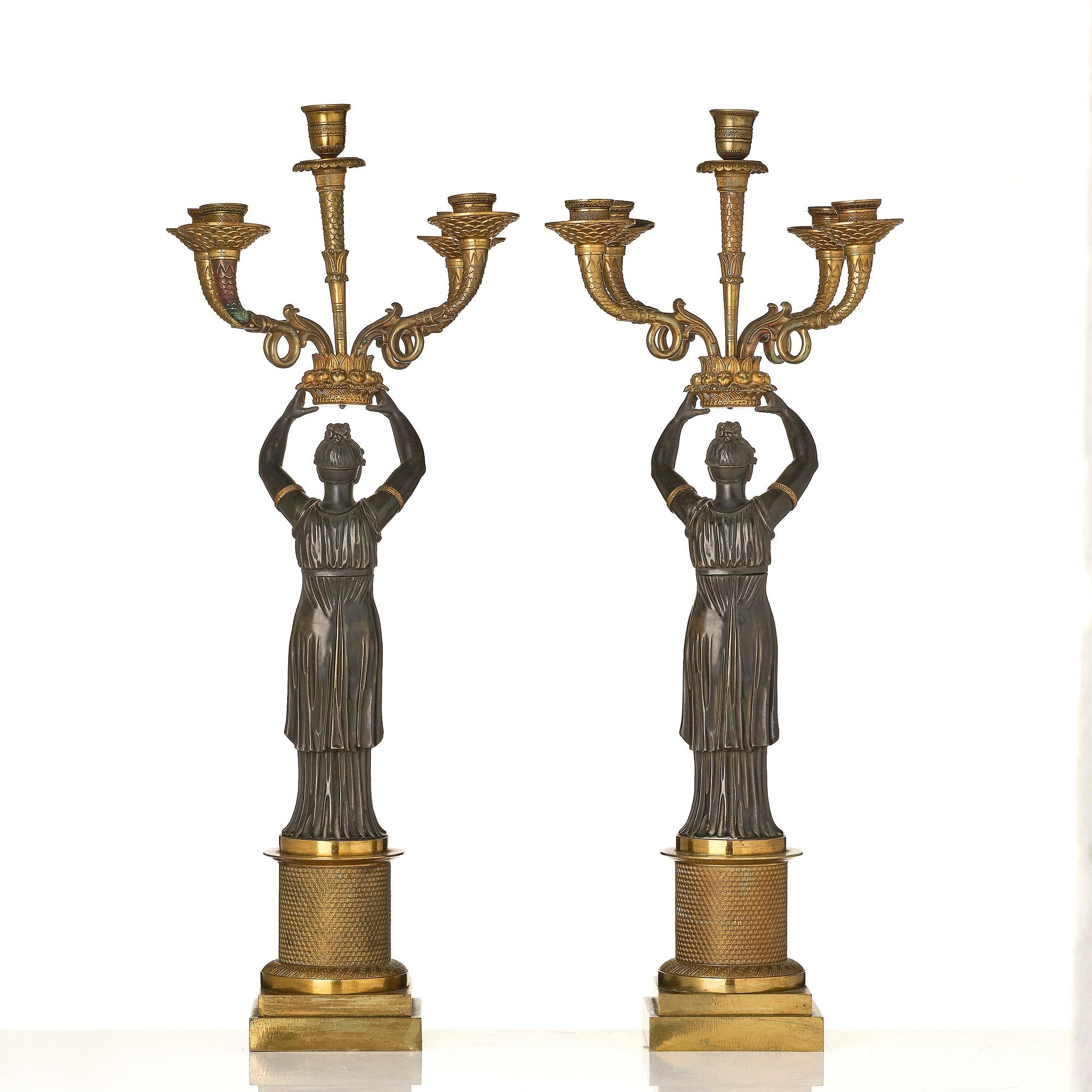 A pair of Fernch Empire ormolu and patinated bronze five-light candelabra, early 19th century.