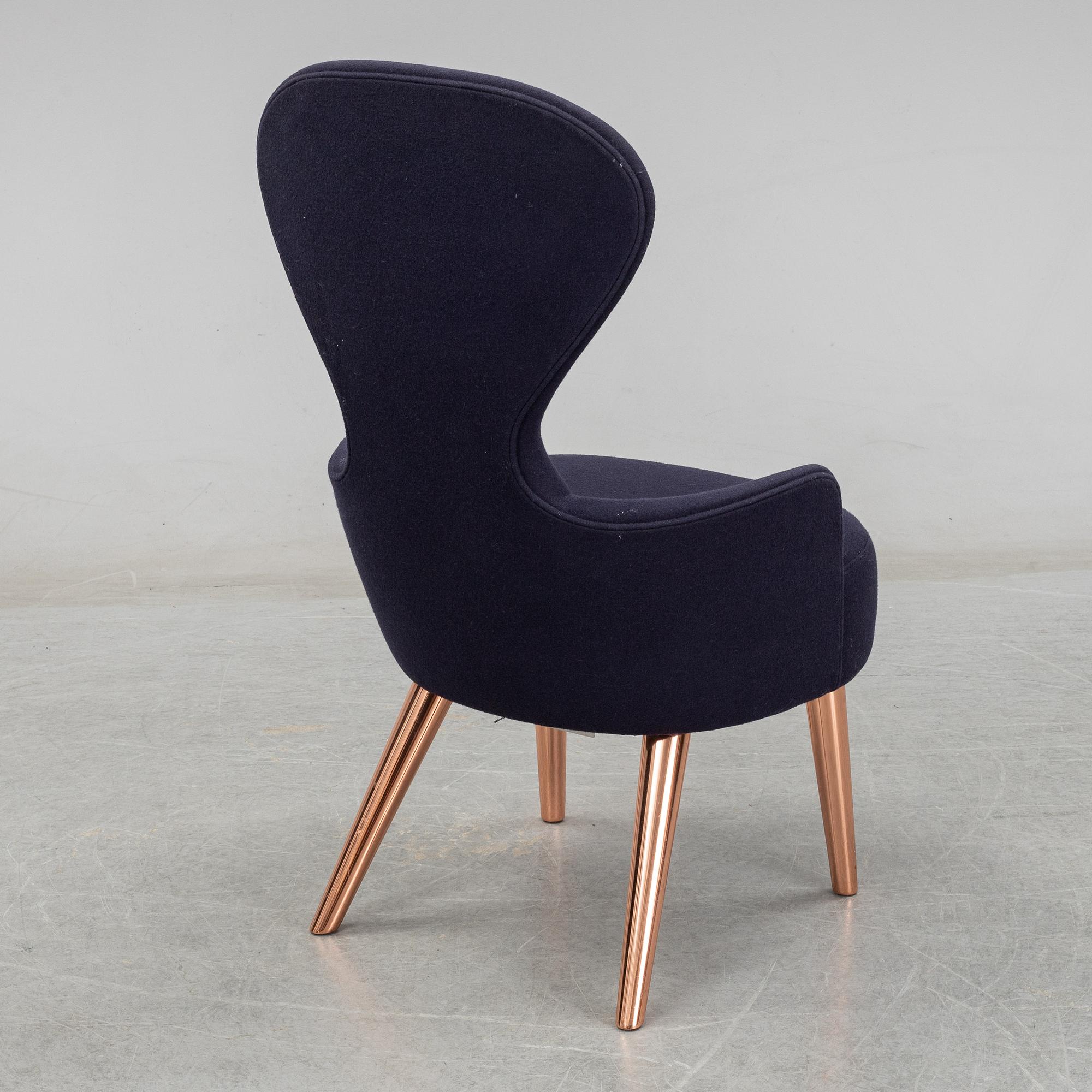 A Tom Dixon "Wingback Dining Chair" from Tom Dixon.