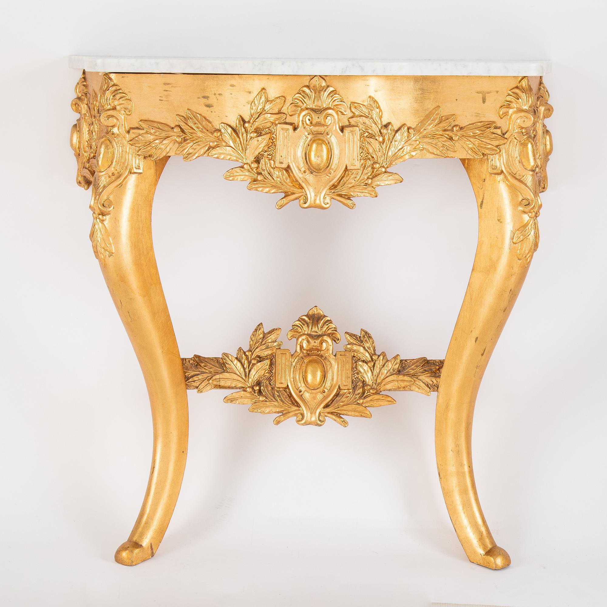 A mirror and console table from around the year 1900.