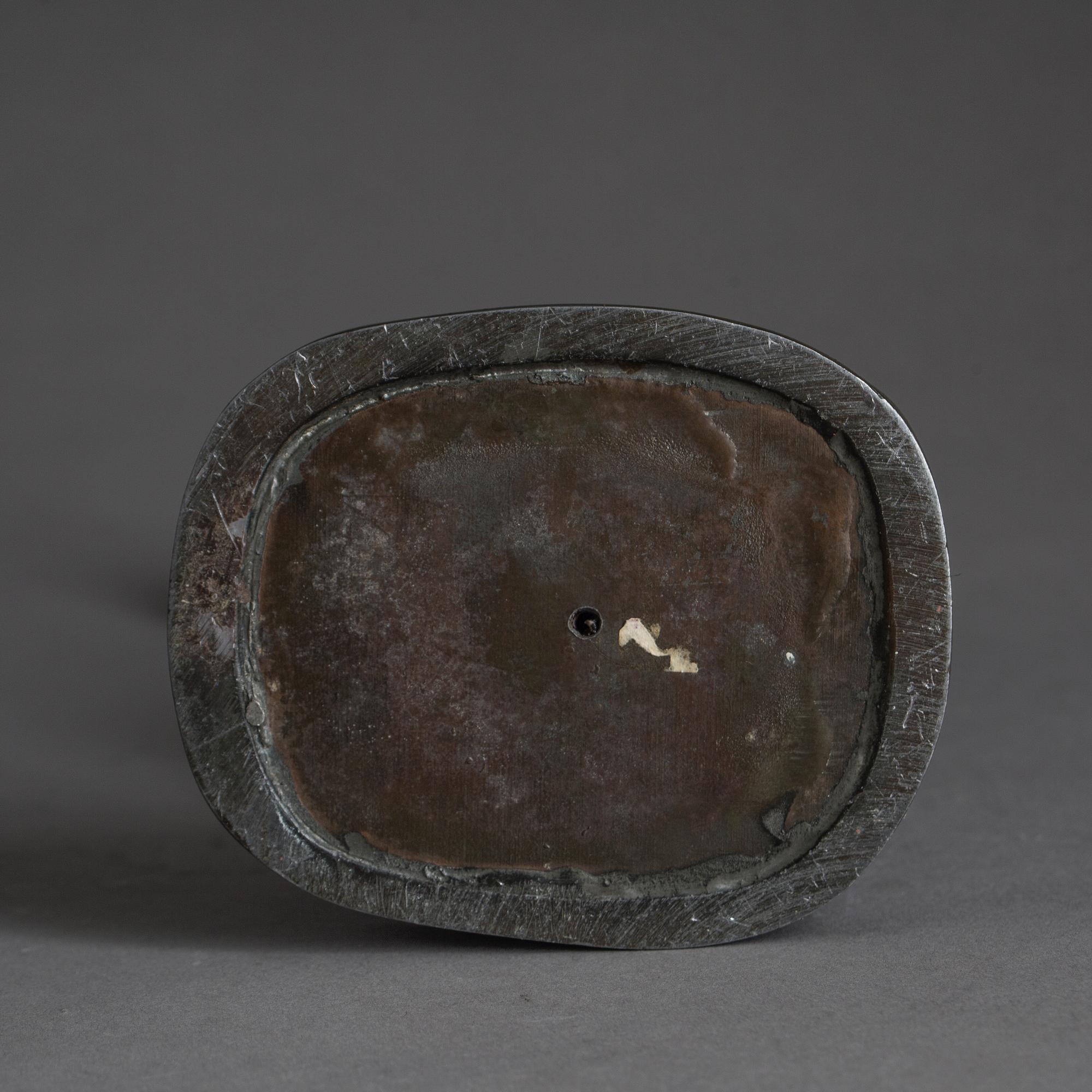 JUST ANDERSEN, a signed metal sculpture.