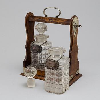 An oak, silver, silverplated and glass tantalus with lock. Second half of the 20th century.