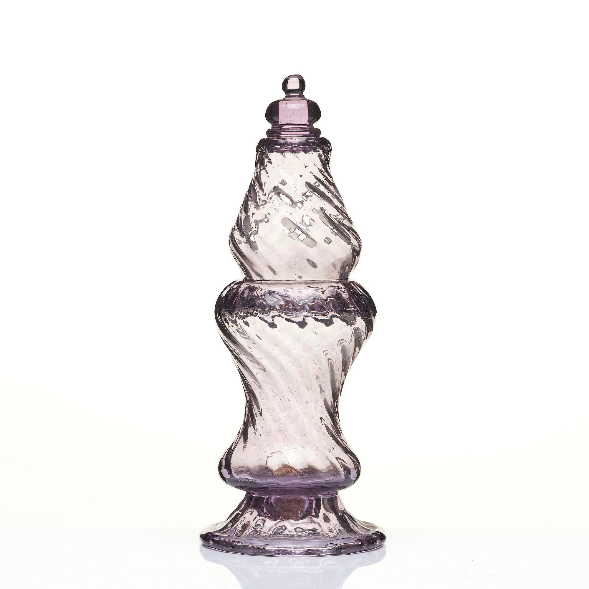 An amethyst coloured suger shaker and a cut glass goblet, 18th century.