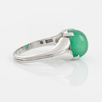 An 18K white gold ring set with a cabochon-cut emerald and eight-cut diamonds.