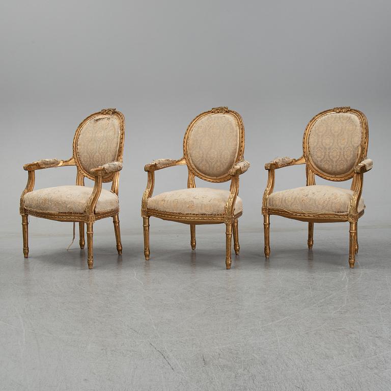 An early 20th century Louis XVI-style sofa and three chairs.