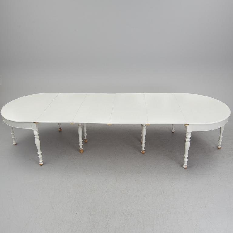 A mid 19th century dining table with six extension leaves.