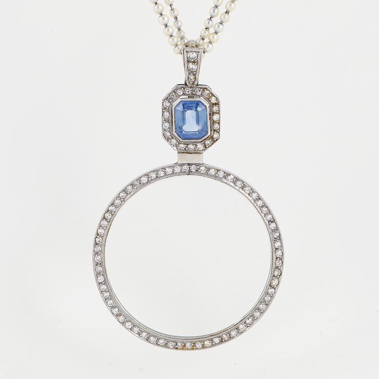 A platinum lorgnette set with a faceted sapphire and rose-cut diamonds.