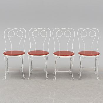 A garden table and four chairs, first half 20th century.