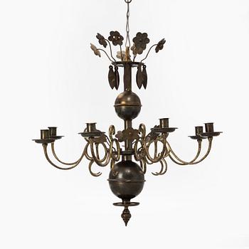 A Baroque style brass chandelier from around the year 1900.