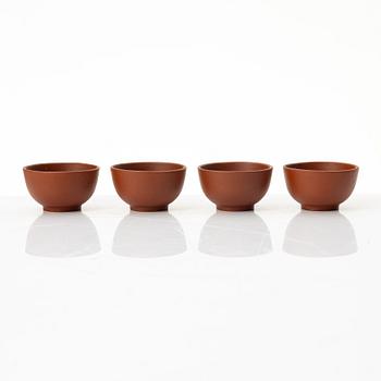 A six part red yixing Gongfu set; teapot, four cups and a tray, China, 1980s.