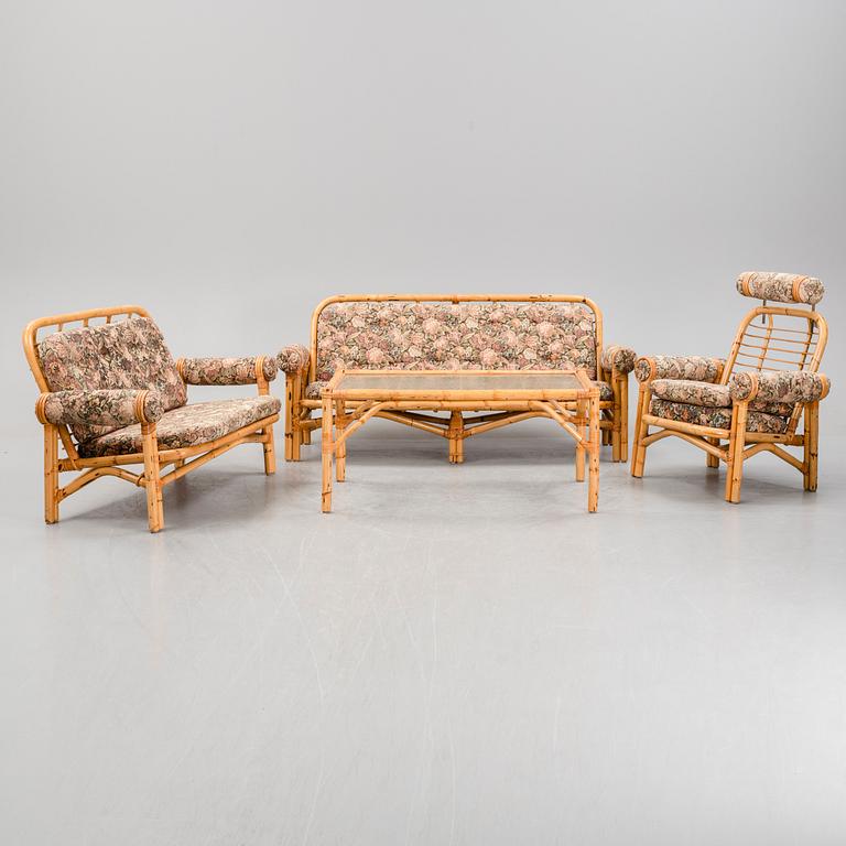 A set of two garden sofas, an armchair and a glass table, later part of the 20th Century.