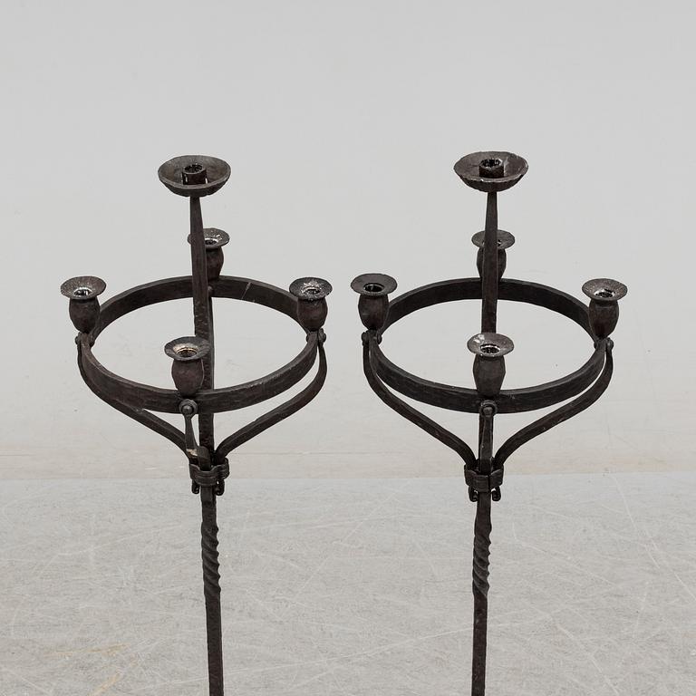 a pair of iron floor candle sticks, 20th century.