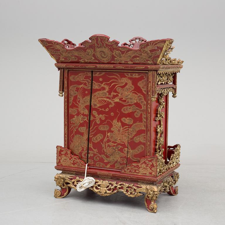 A Chinese red lacqured altar cabinet, late Qing dynasty/early 20th century.