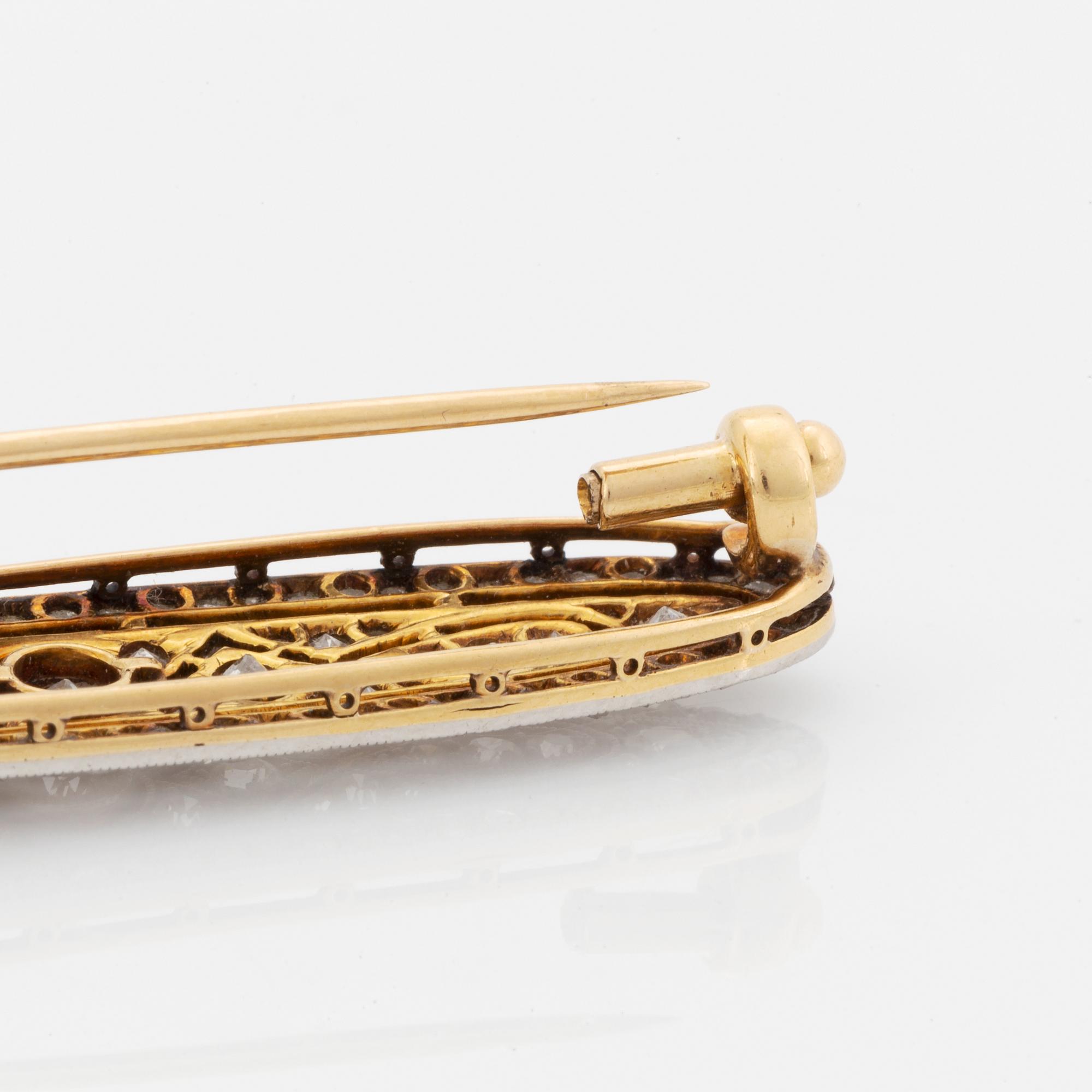 A platinum and 18K gold brooch set with old- and rose-cut diamonds.