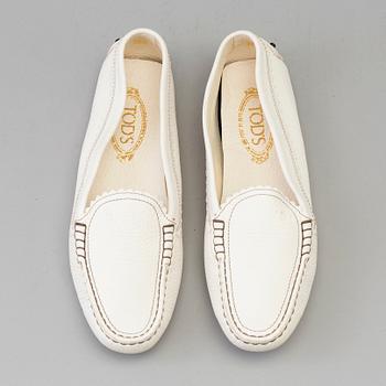 A pair of white leather loafers by Tod's.