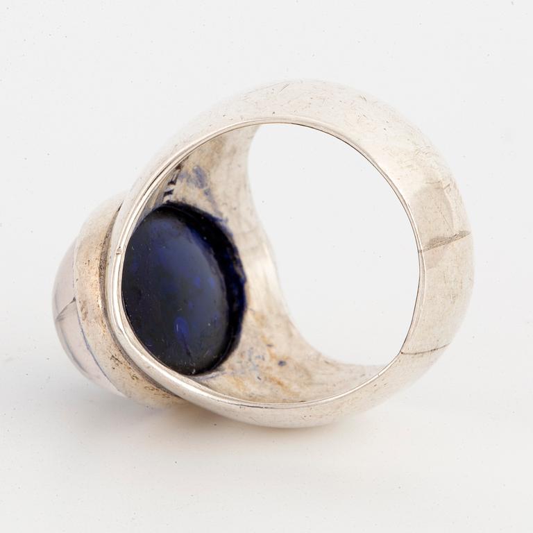 A Rey Urban sterlingsilver ring with cabochon-cut blue stone.