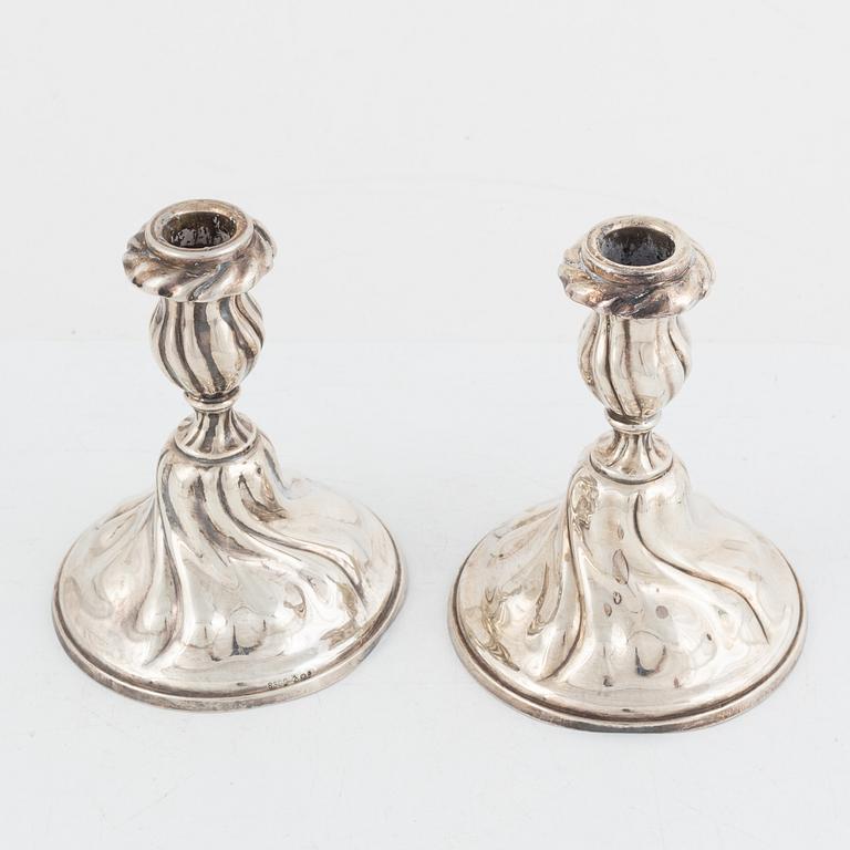 A pair of silver rococ-style candle sticks, presumably Germany, 20th century.