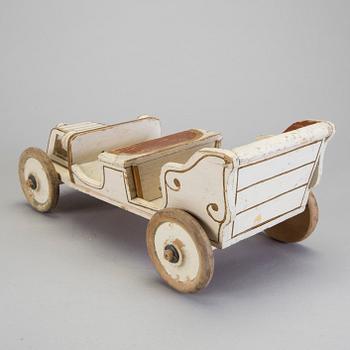 A painted wooden toy car c. 1910.