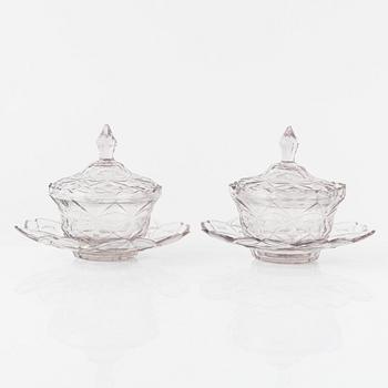 A pair of lidded glass bowls with stands, late 19th century.