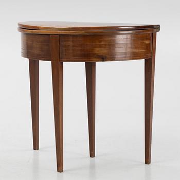 A crescent shaped table, around 1900.