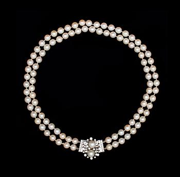 1141. A two strand cultured pearl necklace, app, 8,2 mm, with diamond clasp app. 1.80 cts, 1980's.
