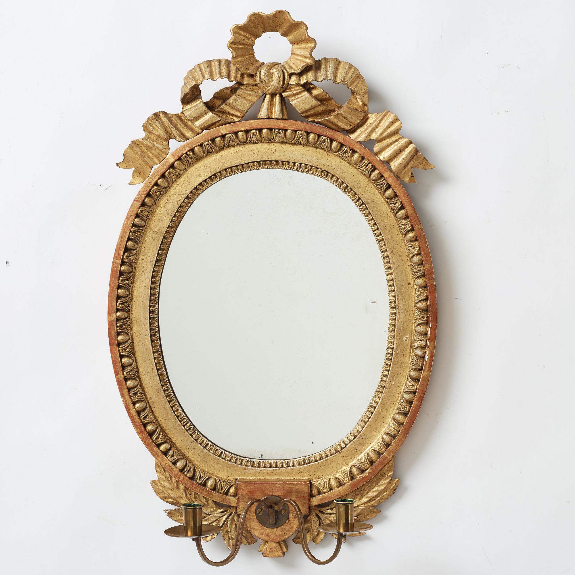 A late gustavian girandole mirror signed by Claes Eric Reding, Karlskrona, (master 1808-1815).
