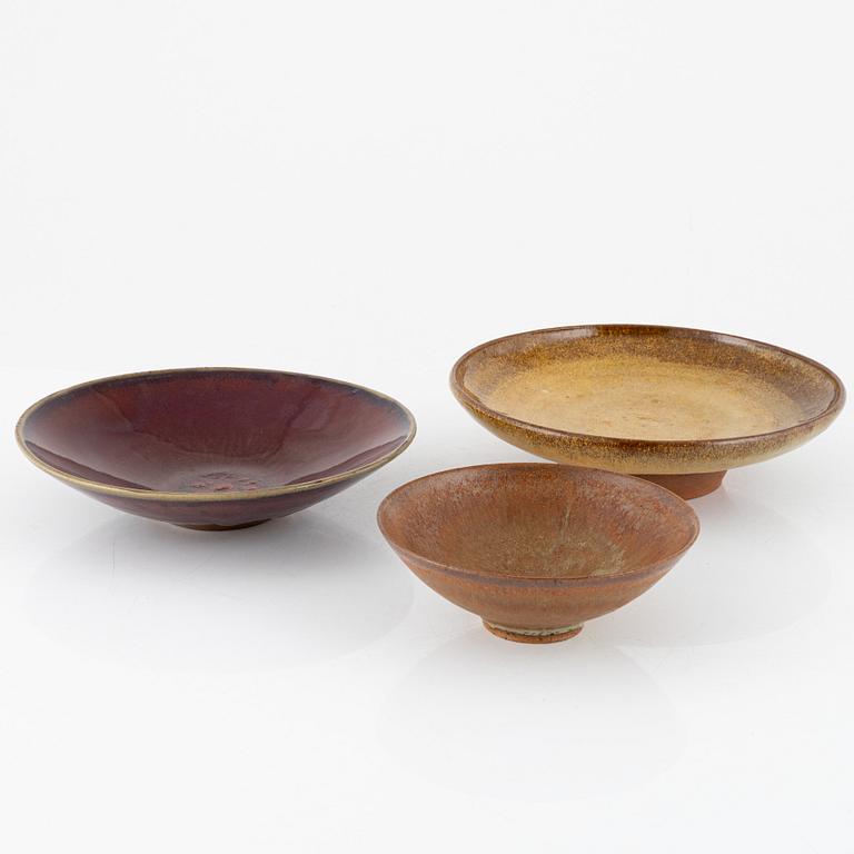 A group of three bowls, including Henning Nilsson, Höganäs.