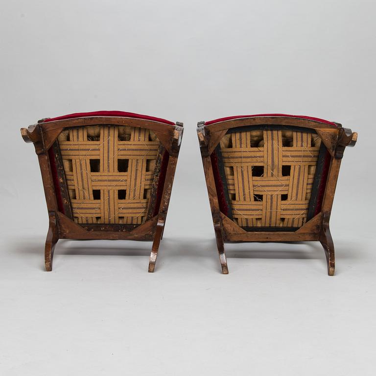 A pair of Russian/Baltic carved mahogany Empire armchairs, first half of the 19th Century.