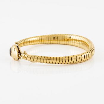 A bracelet in the shape of a serpent in 18K gold with a faceted citrine and rose-cut diamonds.