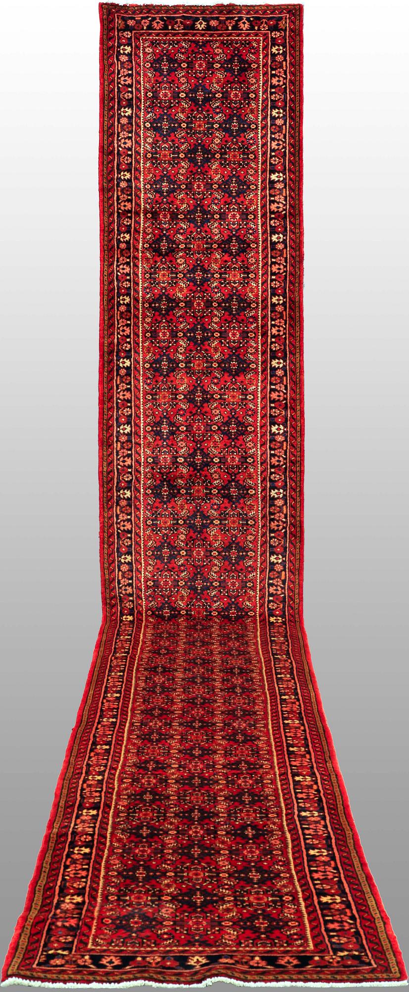 A Hosseinabad runner, c. 605 x 84 cm.