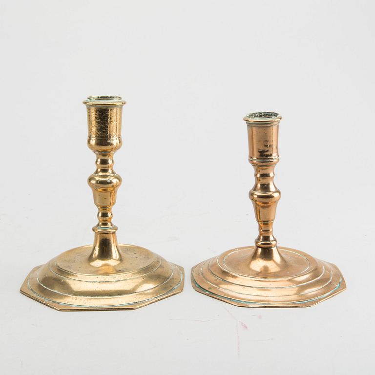 A set of four late Baroque brass candlesticks.