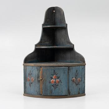 A folk art corner hanging cabinet, 19th century.