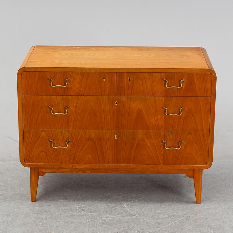 An elm wood venered chest of drawers mid 20th century.