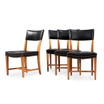 A set of four Josef Frank walnut and black leather chairs, Svenskt Tenn, model 695.