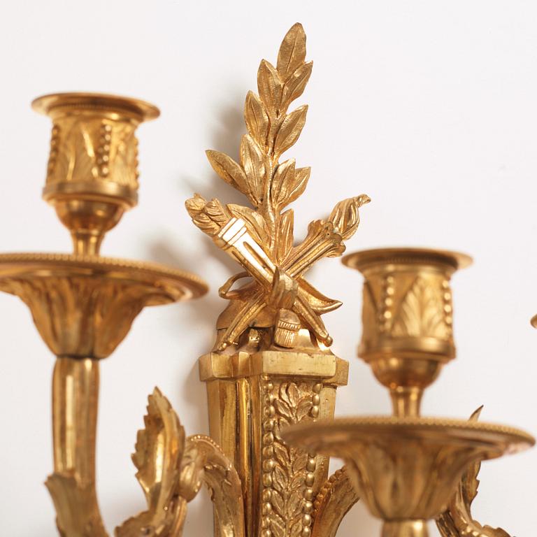 A pair of Louis XVI late 18th century gilt bronze three-light wall-lights.