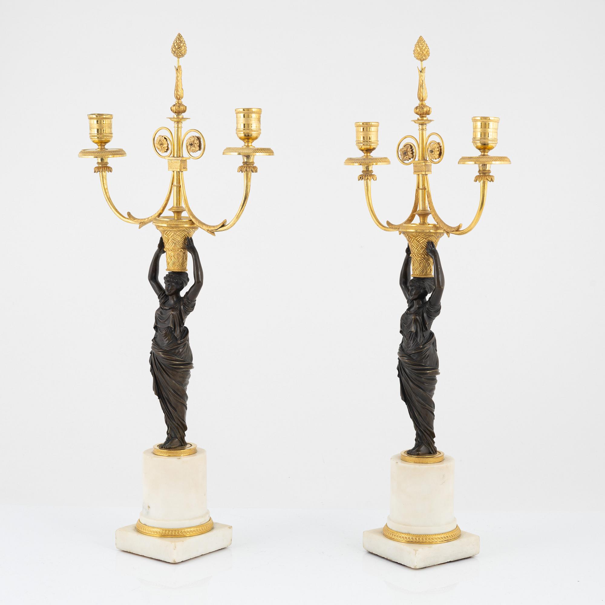 A pair of French Louis XVI ormolu, marble, and patinated bronze two-branch candelabra, late 18th century.