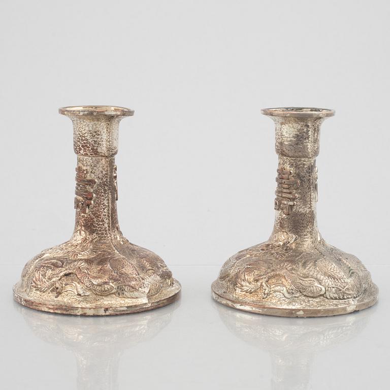 A pair of Chinese silver plated copper candle sticks, 20th century.