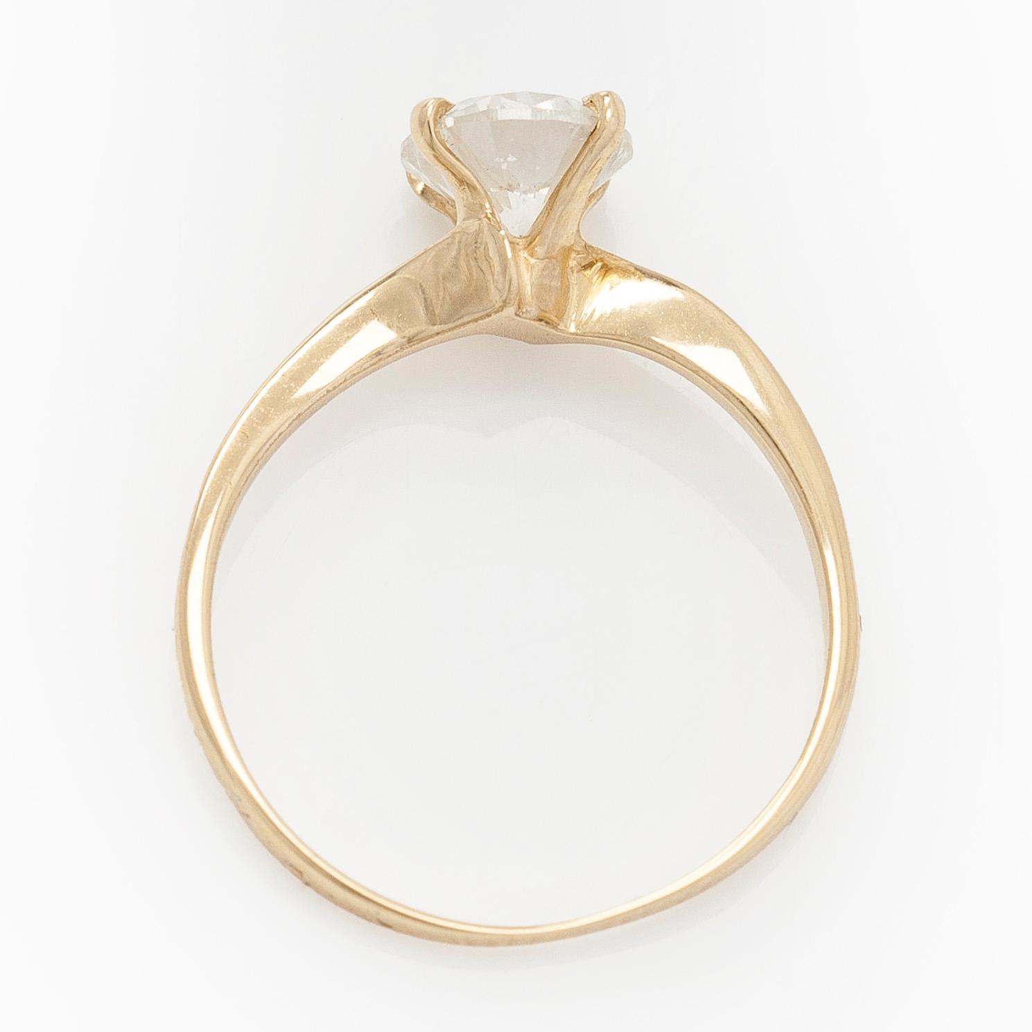 A 14K gold ring with brilliant cut diamond.