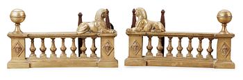 A pair of French Empire 19th century fire-dogs.