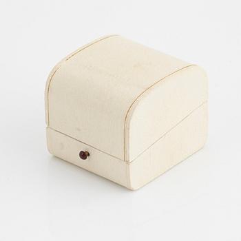 A Sigurd Persson 18K gold ring set with a faceted garnet.