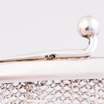 Two silver evening bags and a silver mirror, 1920s-1940s.