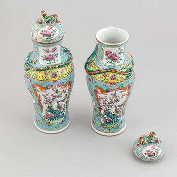 A pair of famille rose canton porcelain vases with covers, Qing dynasty, late 19th century.