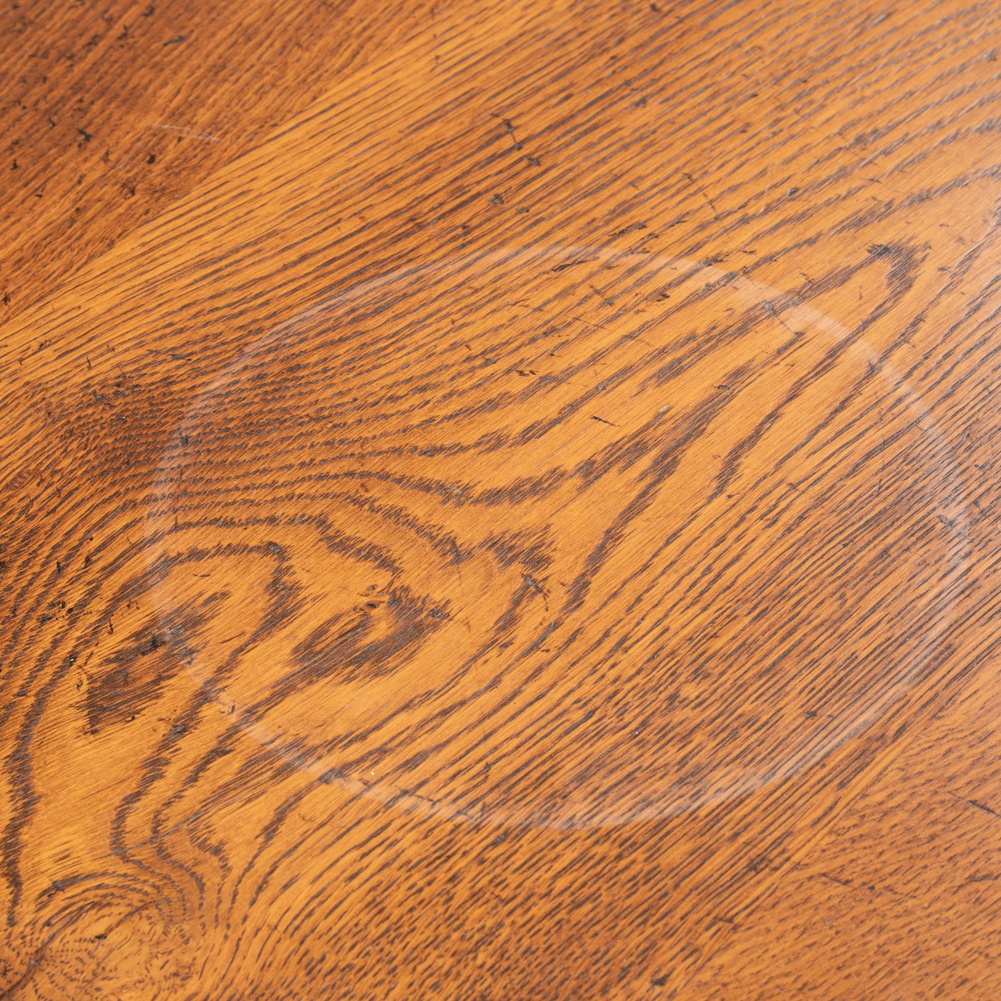 An stained oak dining table with eight chairs.