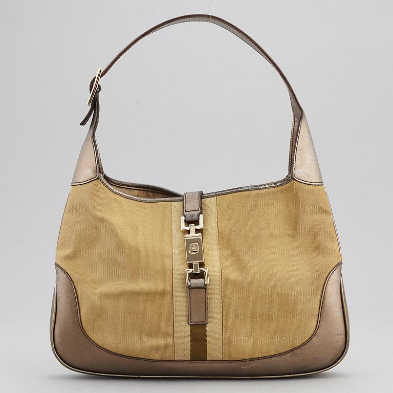 GUCCI, a metallic bag.