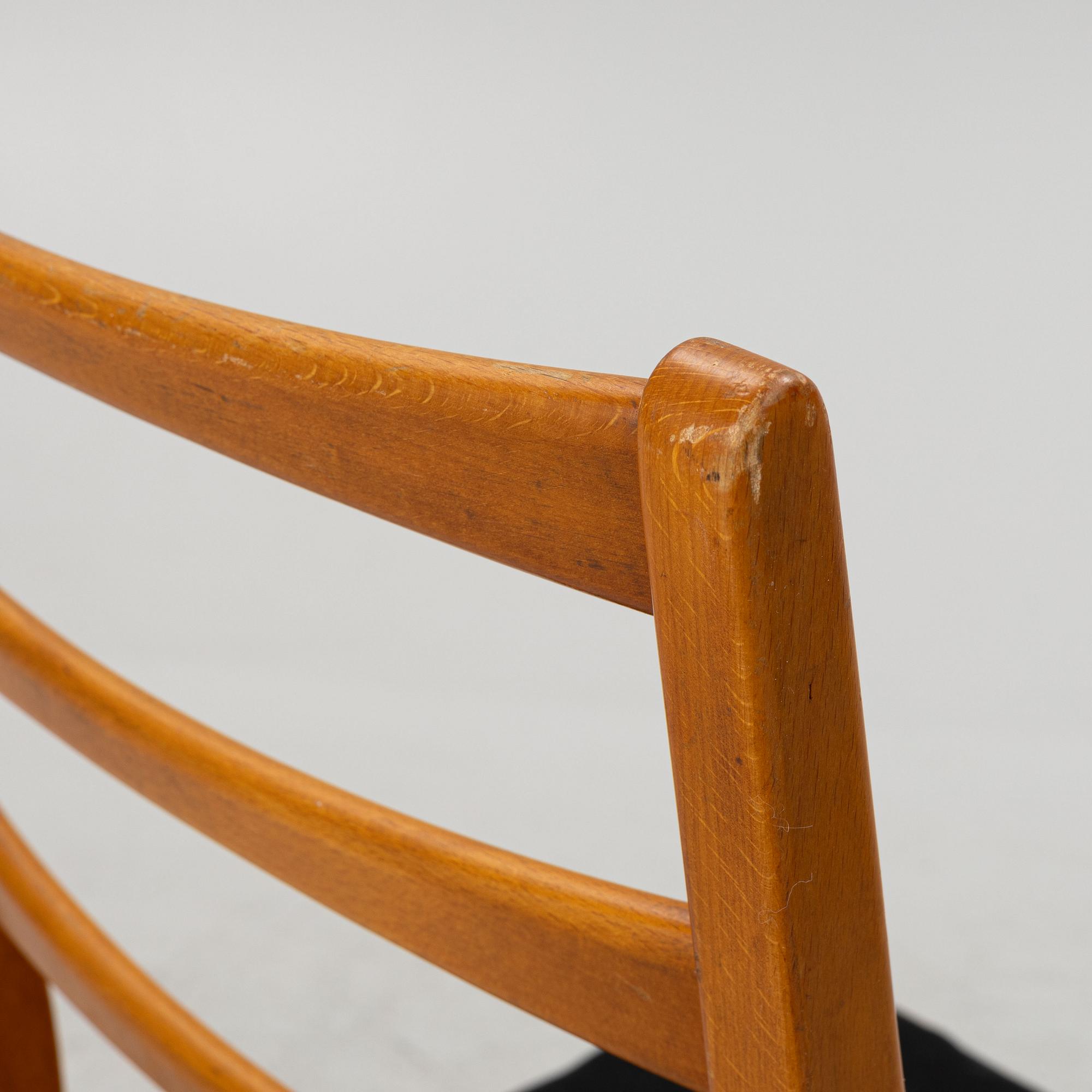 A dining table with four chairs, mid 20th century.